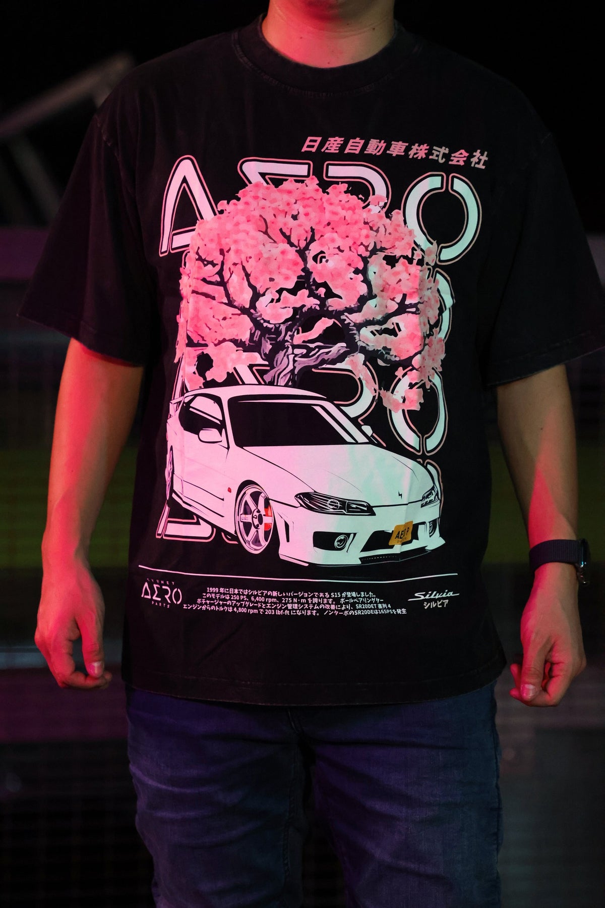 The Touge tee, a black oversized tee with a pink blossom tree and white S15 Silvia print
