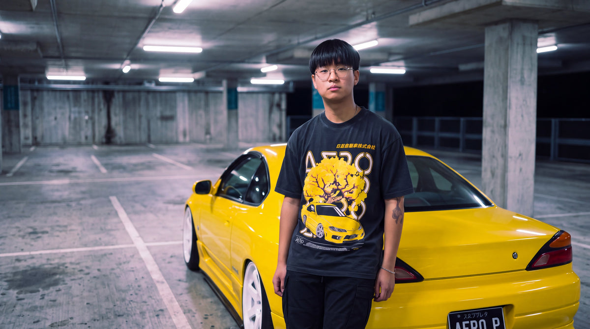 The Goldrush Tee in an underground car park at night, with a yellow S15 Silvia behind him